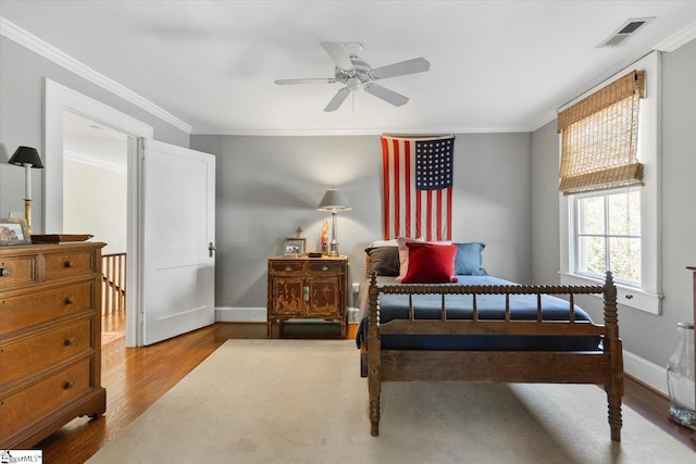 bedroom featuring ornamental molding, ceiling fan, and hardwood / wood-style floors