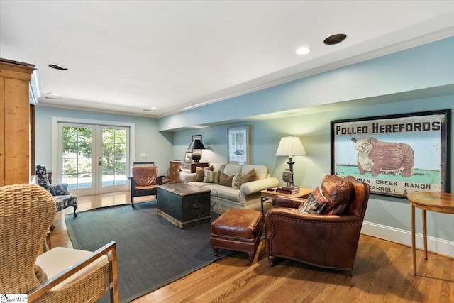 living room featuring french doors, hardwood / wood-style flooring, and crown molding