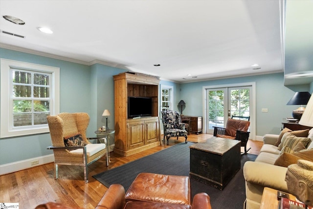 living room featuring wood-type flooring and crown molding