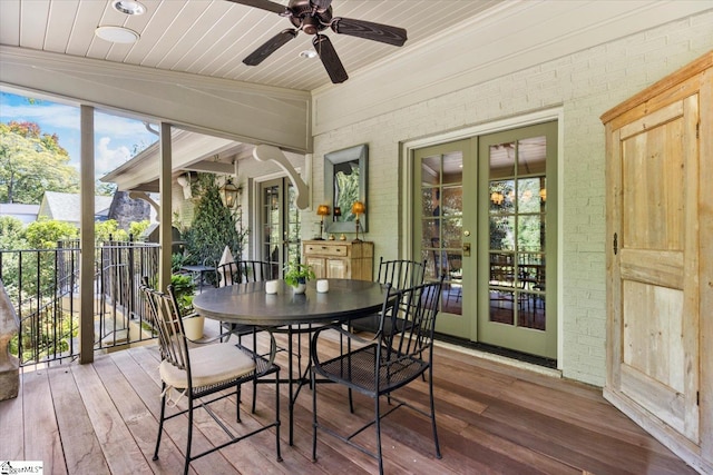 sunroom with wood ceiling, vaulted ceiling, ceiling fan, and french doors