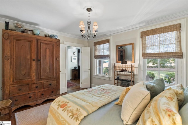 bedroom featuring wood-type flooring, a chandelier, ornamental molding, and multiple windows