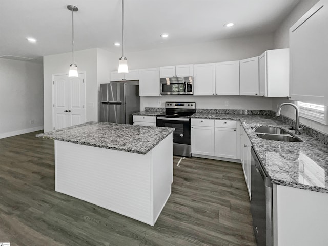 kitchen featuring sink, white cabinetry, appliances with stainless steel finishes, dark hardwood / wood-style floors, and a center island