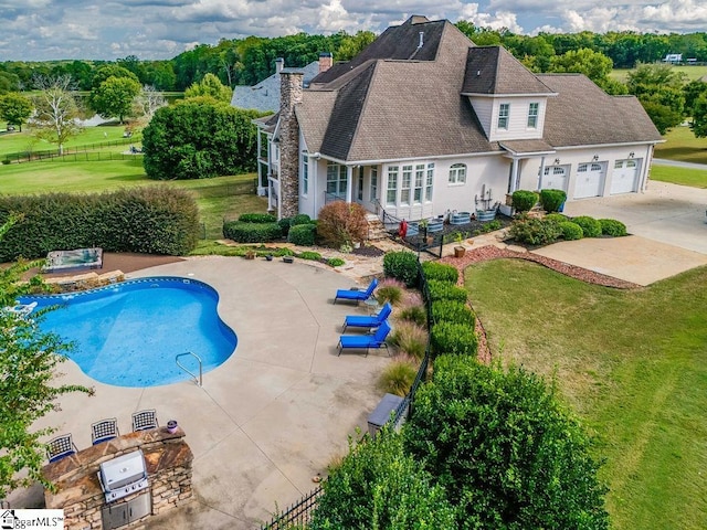 view of swimming pool featuring a patio and a yard