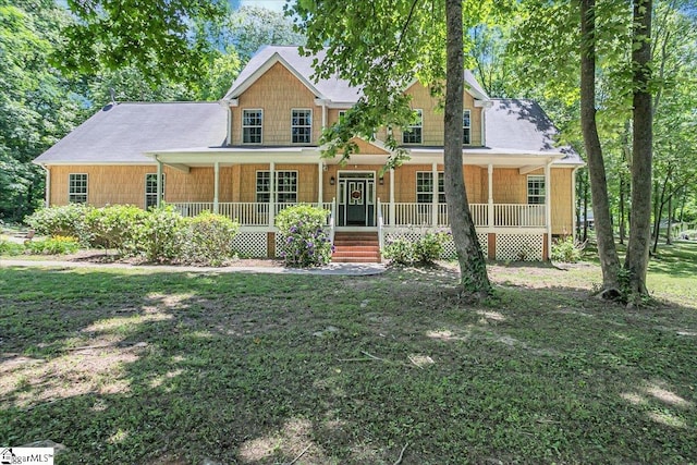 view of front facade with a front yard and covered porch