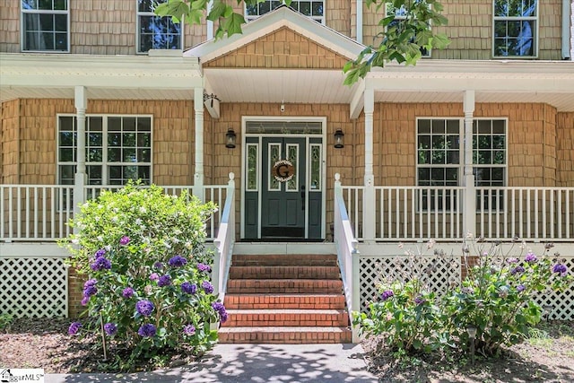 view of exterior entry with a porch