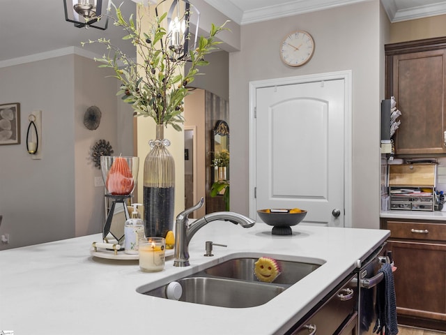 kitchen with dark brown cabinets, crown molding, and sink