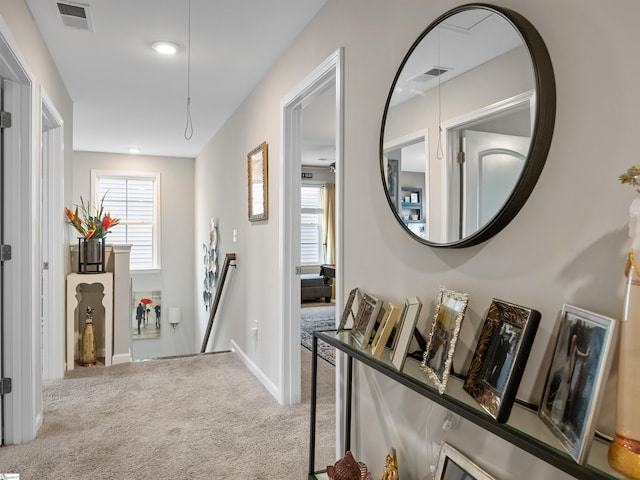 hallway with light colored carpet