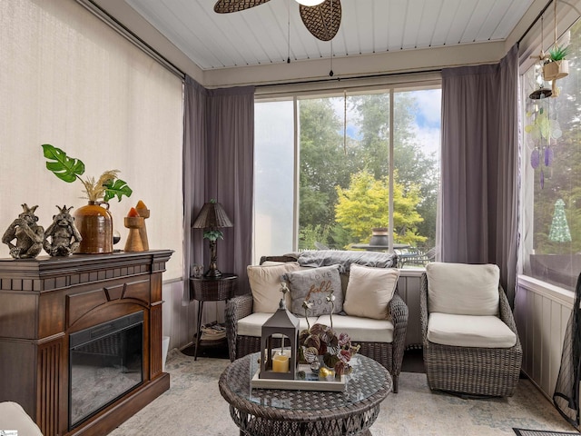 sunroom with wood ceiling and ceiling fan