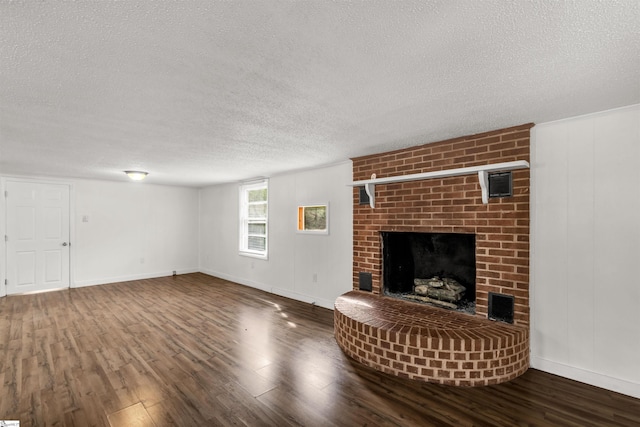 unfurnished living room with hardwood / wood-style floors, a textured ceiling, and a fireplace