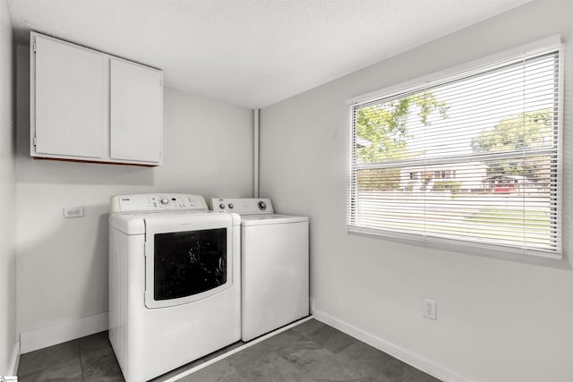 laundry area featuring cabinets, a textured ceiling, and independent washer and dryer