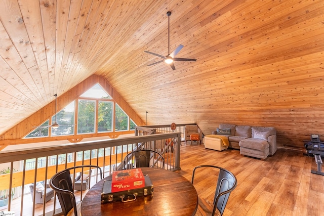 interior space with wood ceiling, vaulted ceiling, ceiling fan, light hardwood / wood-style flooring, and wooden walls