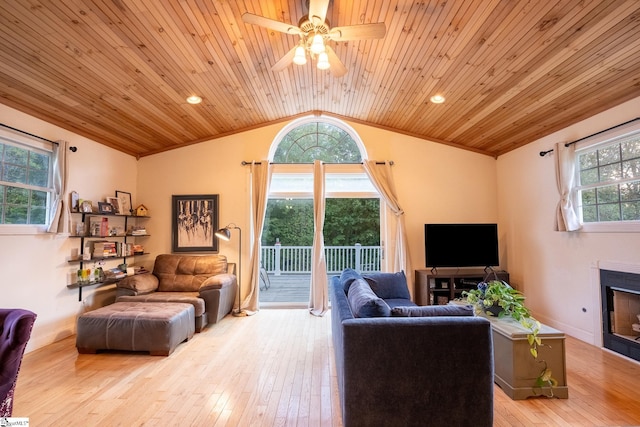 living room featuring lofted ceiling, light hardwood / wood-style floors, ceiling fan, and wooden ceiling