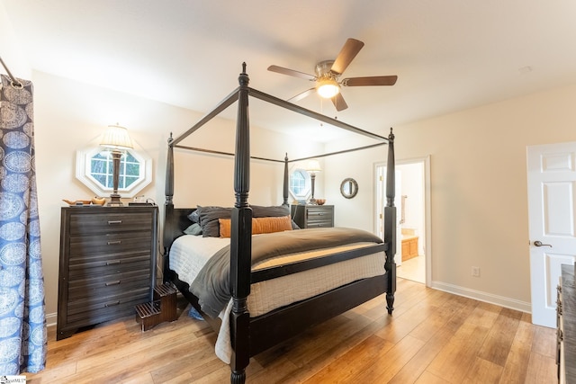 bedroom with light wood-type flooring, ensuite bath, and ceiling fan