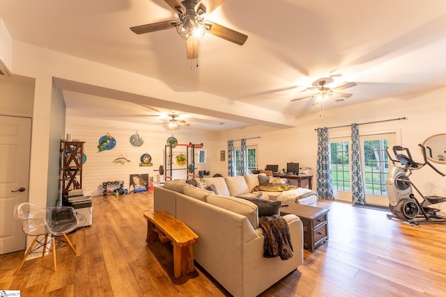 living room with ceiling fan and wood-type flooring