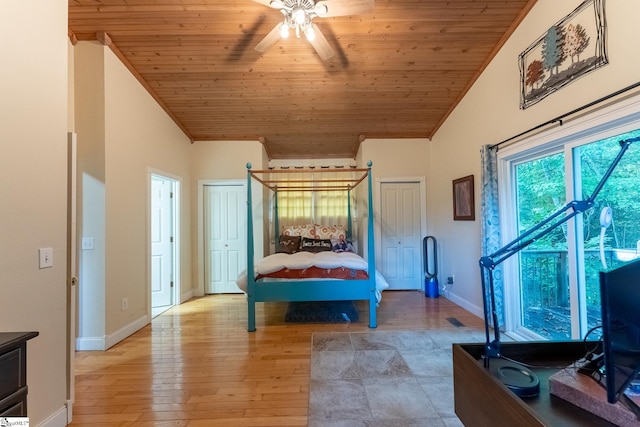 bedroom with light wood-type flooring, lofted ceiling, crown molding, ceiling fan, and wooden ceiling