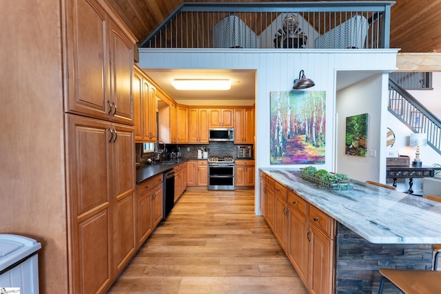 kitchen with wood ceiling, wine cooler, stainless steel appliances, light wood-type flooring, and sink