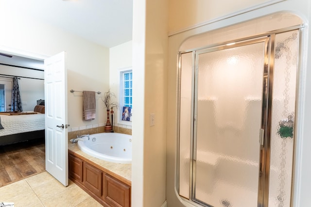 bathroom with shower with separate bathtub and hardwood / wood-style flooring