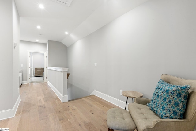 sitting room with vaulted ceiling and light hardwood / wood-style flooring