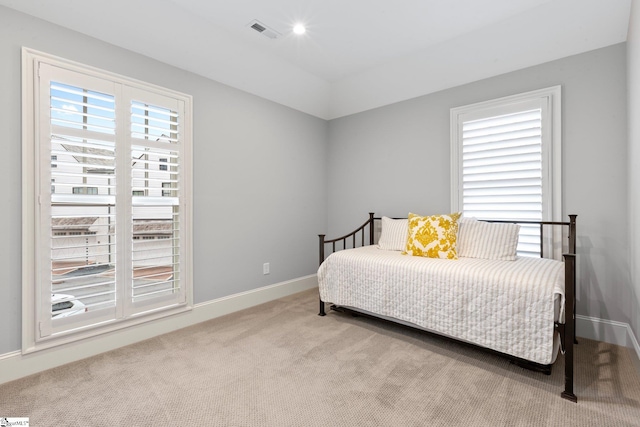 bedroom featuring light colored carpet