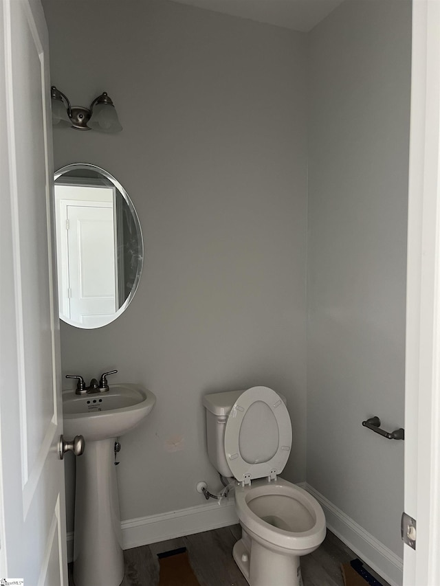 bathroom with sink, hardwood / wood-style floors, and toilet