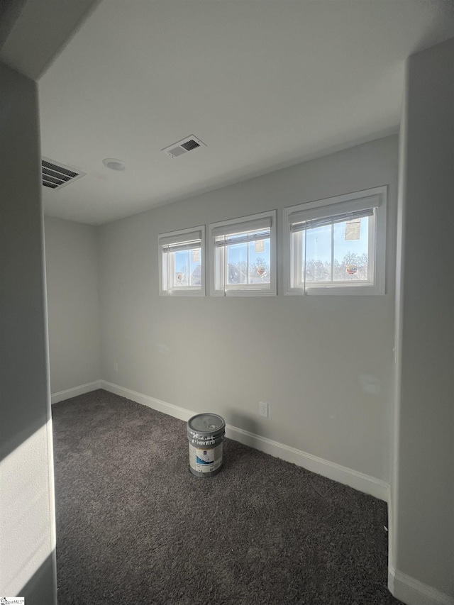 carpeted spare room featuring plenty of natural light