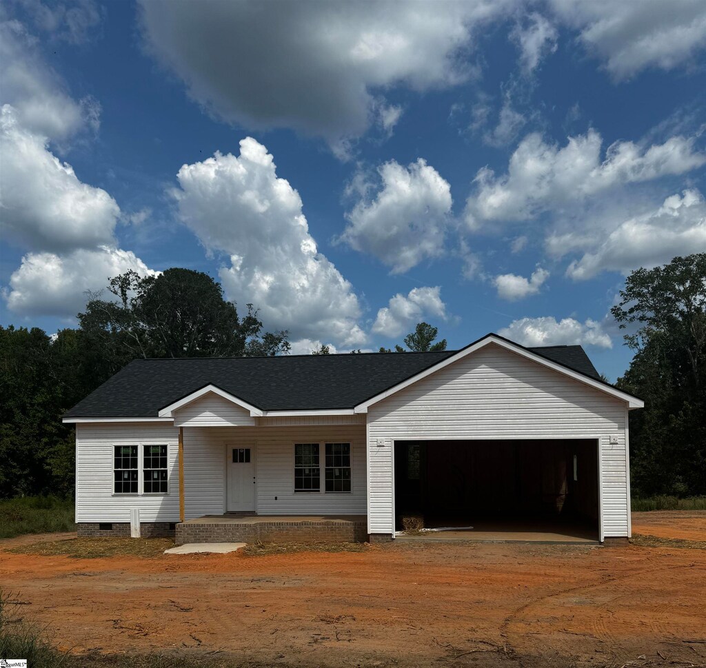 single story home featuring a garage and a porch