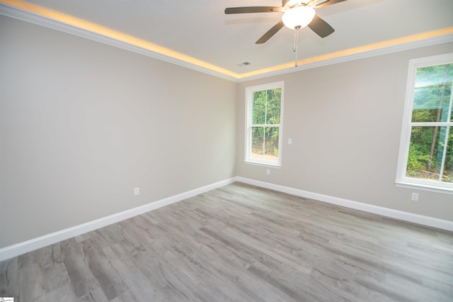 unfurnished room featuring ceiling fan, crown molding, baseboards, and wood finished floors
