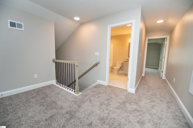 hallway with an upstairs landing, vaulted ceiling, carpet flooring, recessed lighting, and baseboards