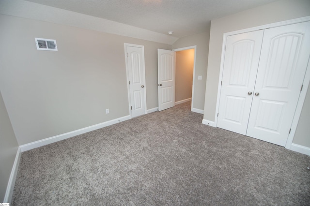unfurnished bedroom featuring carpet flooring and baseboards
