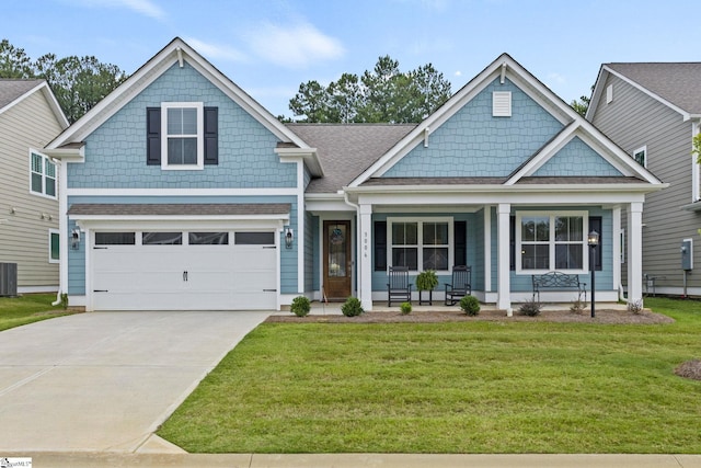 craftsman house featuring a garage, a front lawn, covered porch, and central air condition unit