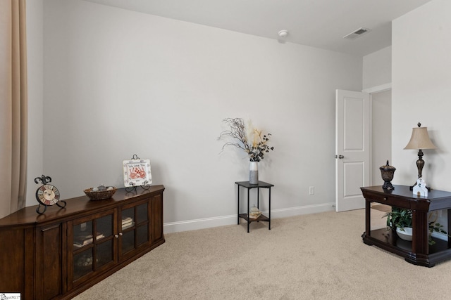 sitting room featuring light colored carpet