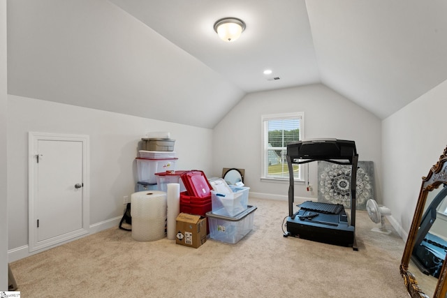 interior space featuring light colored carpet and lofted ceiling