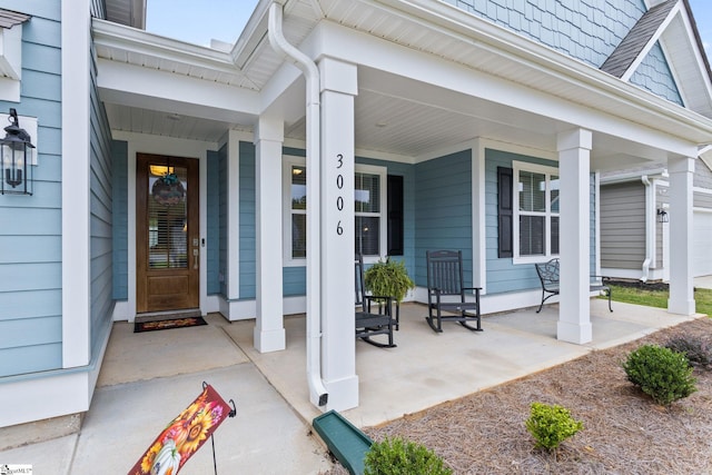 view of exterior entry with covered porch