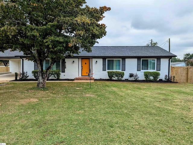 ranch-style home featuring a front yard