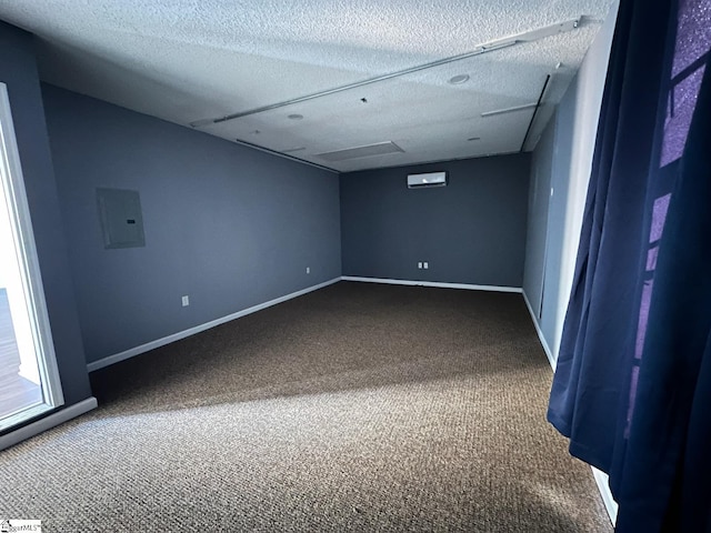 carpeted empty room featuring a textured ceiling and electric panel