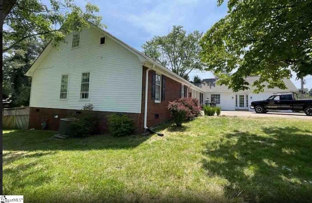 view of property exterior featuring a yard and central AC unit