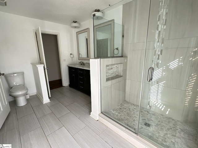 bathroom featuring vanity, toilet, and an enclosed shower