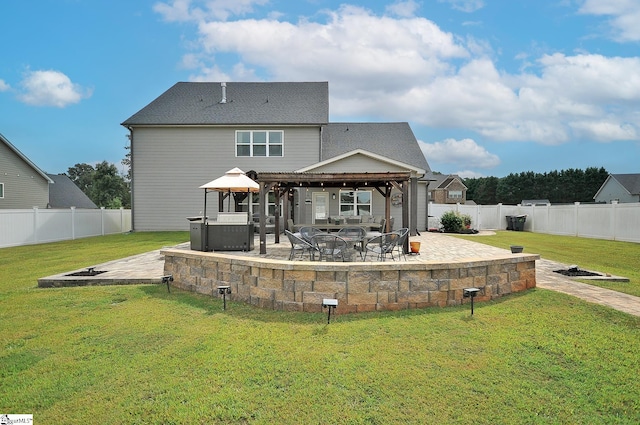 rear view of property featuring a fire pit, a patio area, a gazebo, and a yard