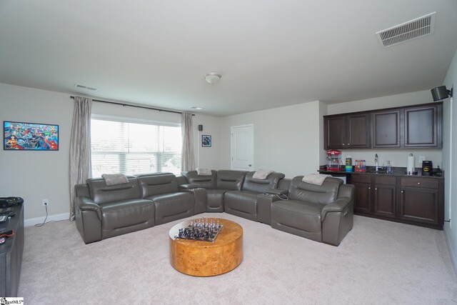 living room featuring sink and light colored carpet