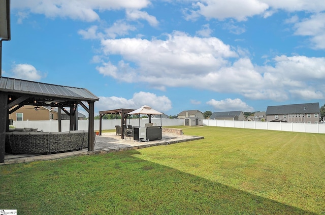 view of yard featuring ceiling fan, a patio area, and a gazebo