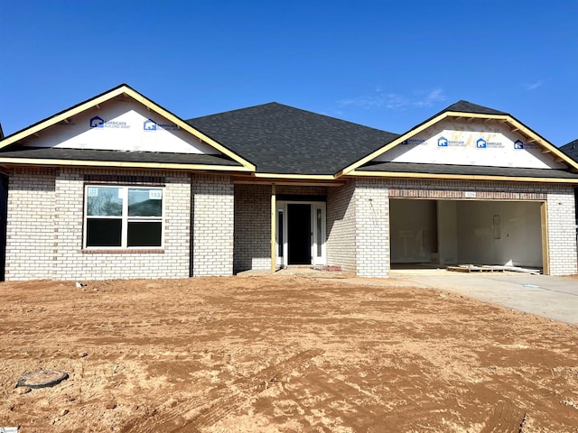 view of front of property featuring concrete driveway, brick siding, and an attached garage