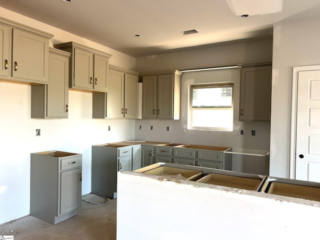 kitchen with concrete floors and gray cabinetry