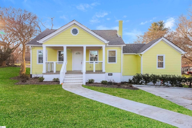 bungalow with a front yard and covered porch