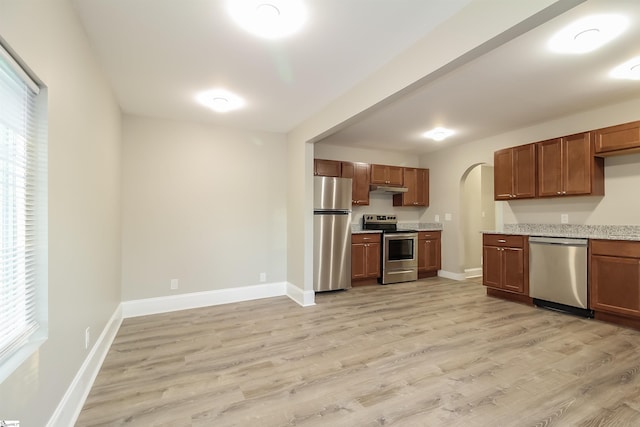 kitchen featuring light hardwood / wood-style floors, stainless steel appliances, and a wealth of natural light