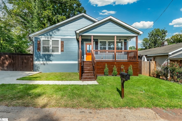 bungalow with a front yard and a porch