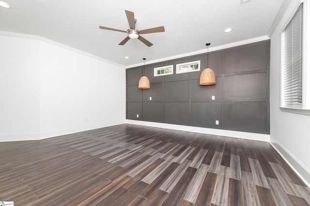 interior space featuring ceiling fan, dark hardwood / wood-style floors, ornamental molding, and plenty of natural light