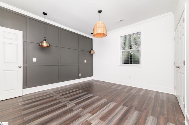 empty room featuring ornamental molding and dark wood-type flooring