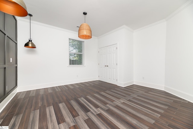 spare room with crown molding and dark wood-type flooring