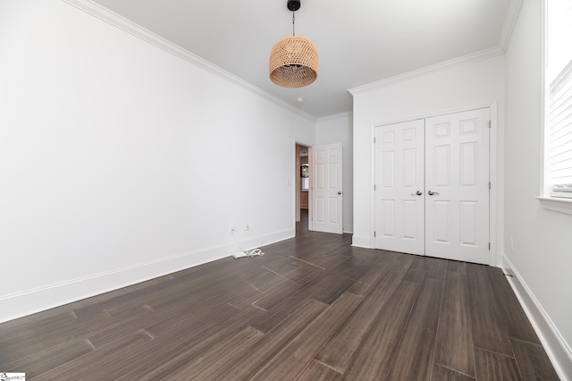 unfurnished bedroom with a closet, dark hardwood / wood-style floors, and crown molding