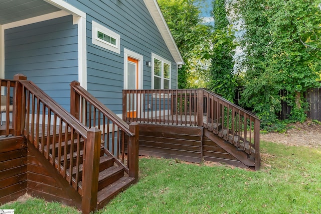 wooden deck featuring a lawn